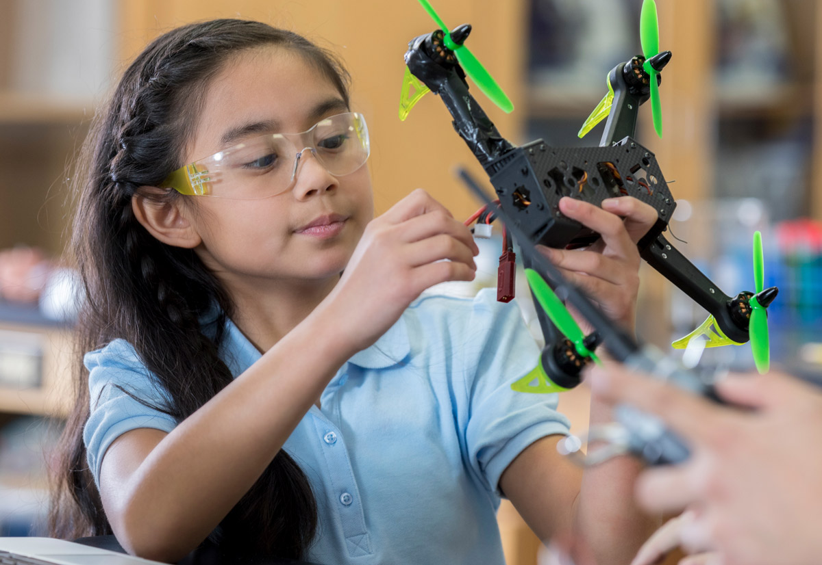 young girl working on a drone