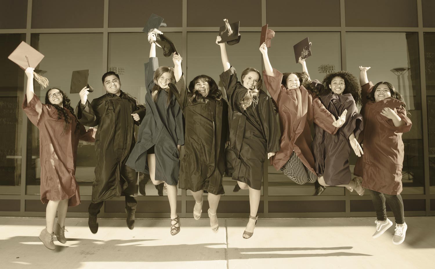 Chaffey Joint Union High School Students Jumping With Graduation Gear