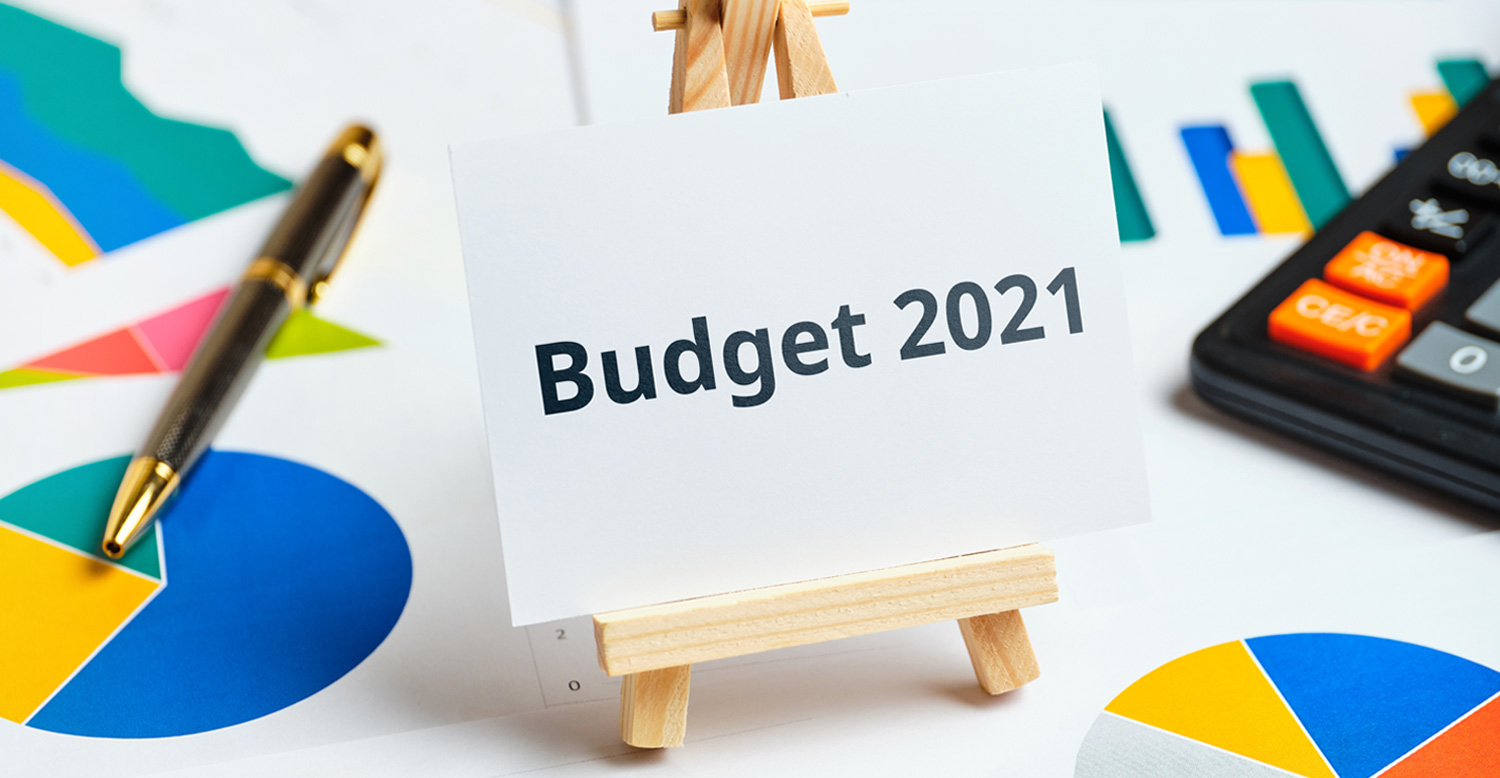 miniature wooden easel with a small sign reading "Budget 2021"