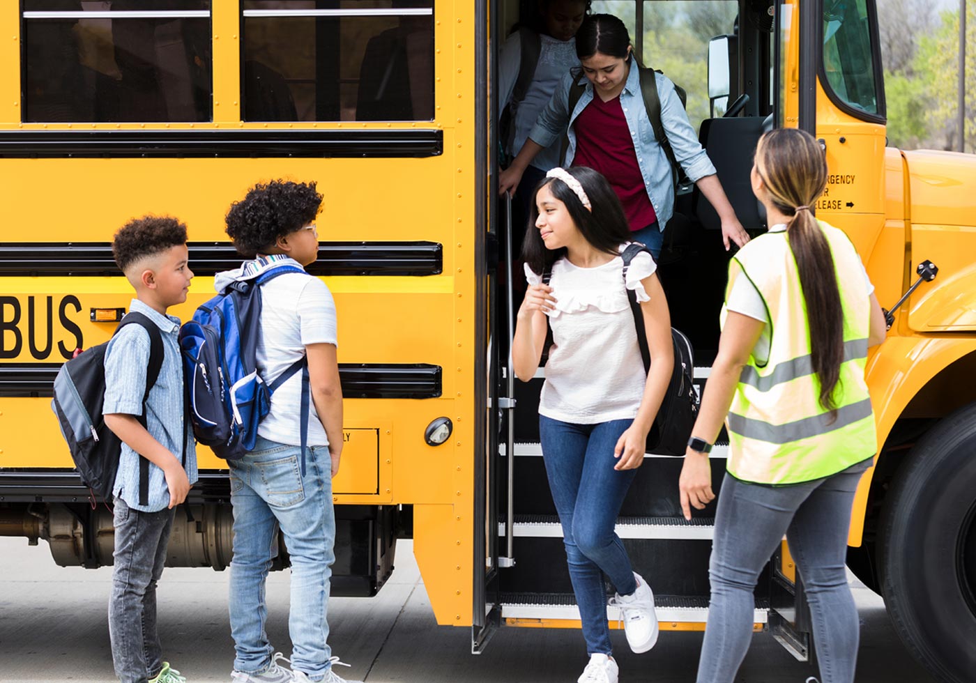 students depart a school bus under an attendants supervision