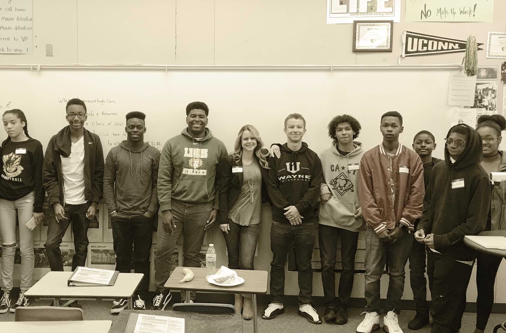 high school students stand for a group photo in class
