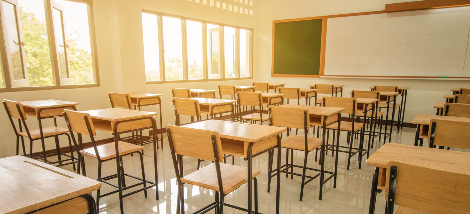 an empty classroom filled with desks and chairs