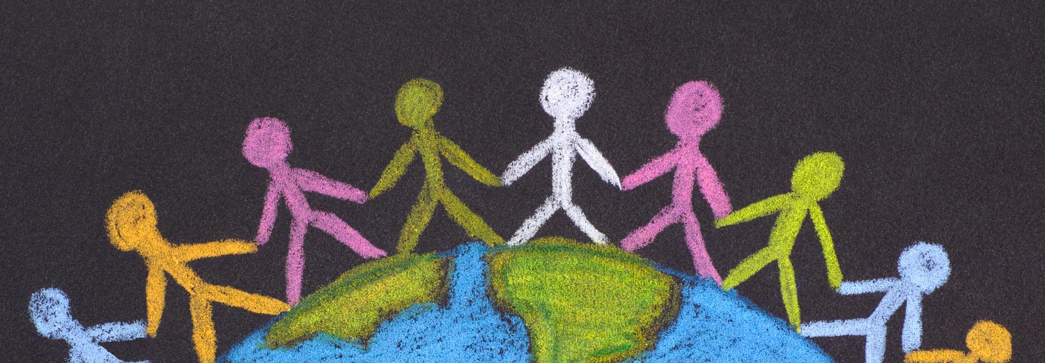 a chalkboard drawing of stick figures joined at the hands surrounding the Earth