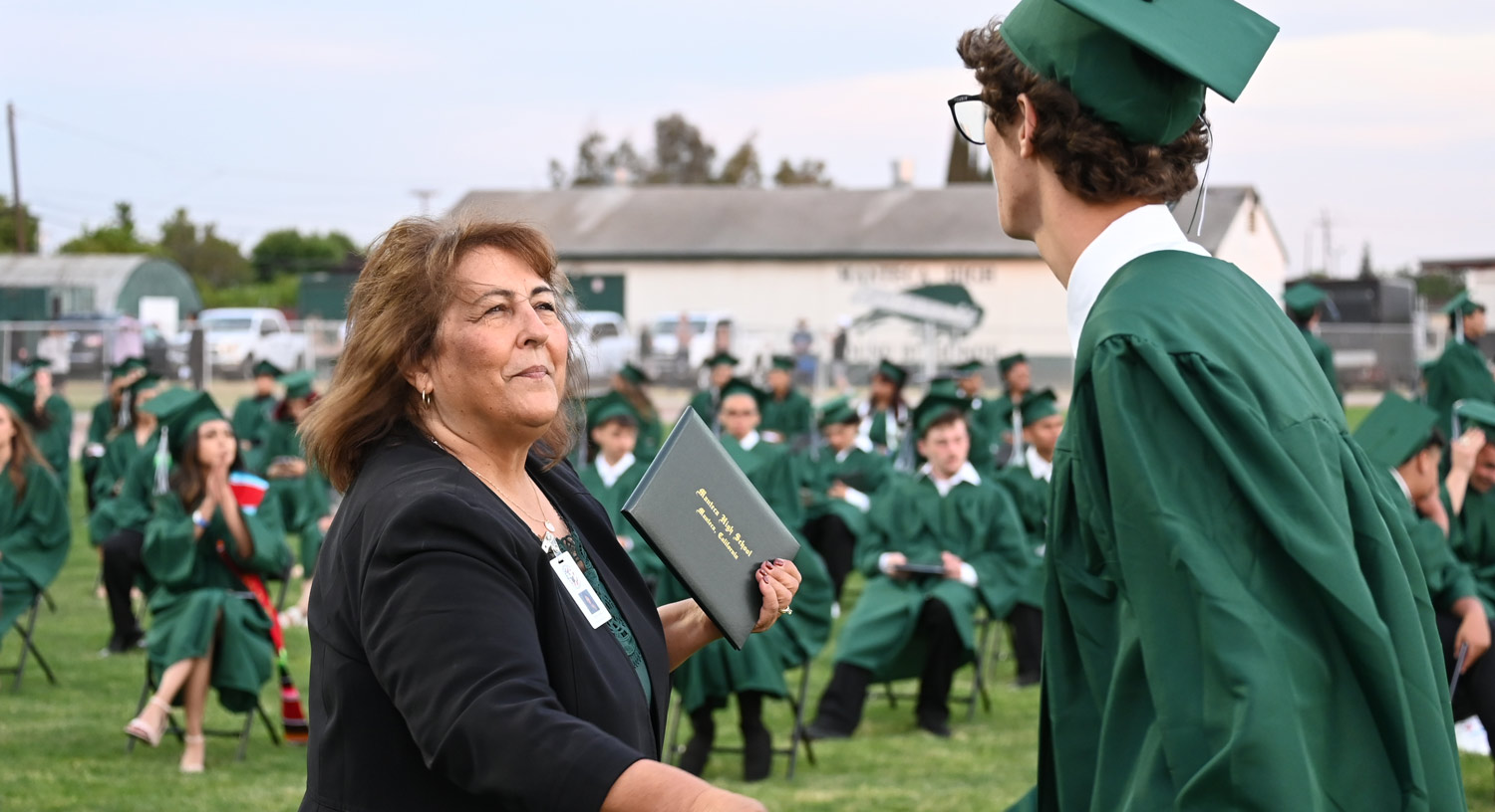 Marie Freitas congratulating student at graduation ceremony