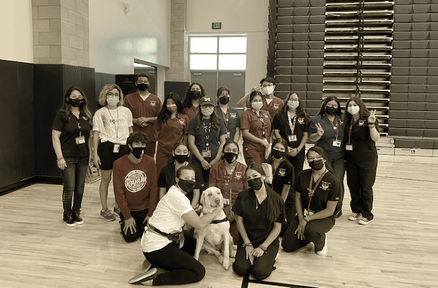 Students posing with a service dog