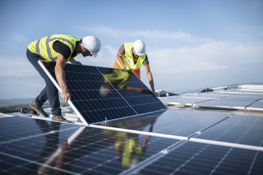construction workers installing solar panels