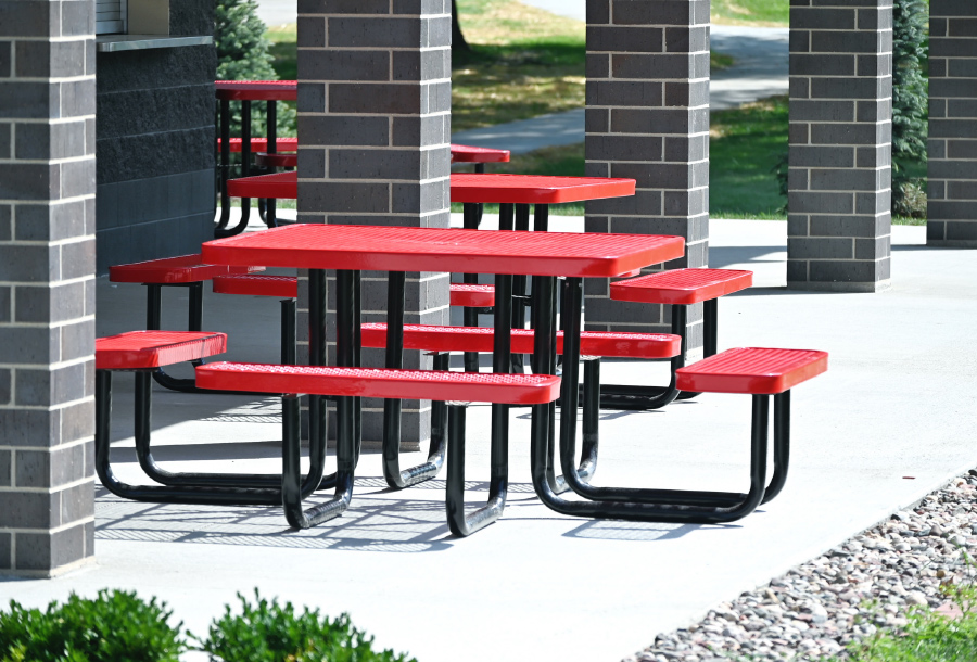 red lunch table in the middle of a school courtyard