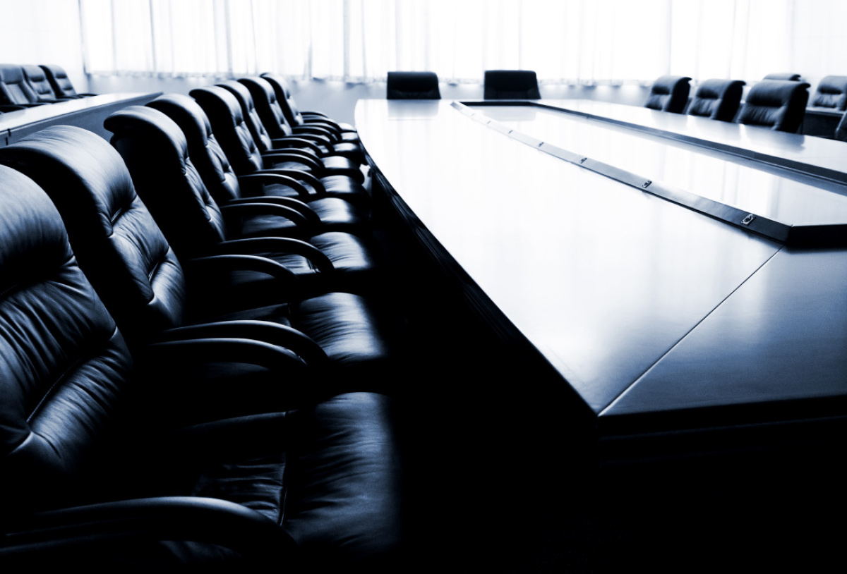 view along a line of chairs beside a table in a boardroom