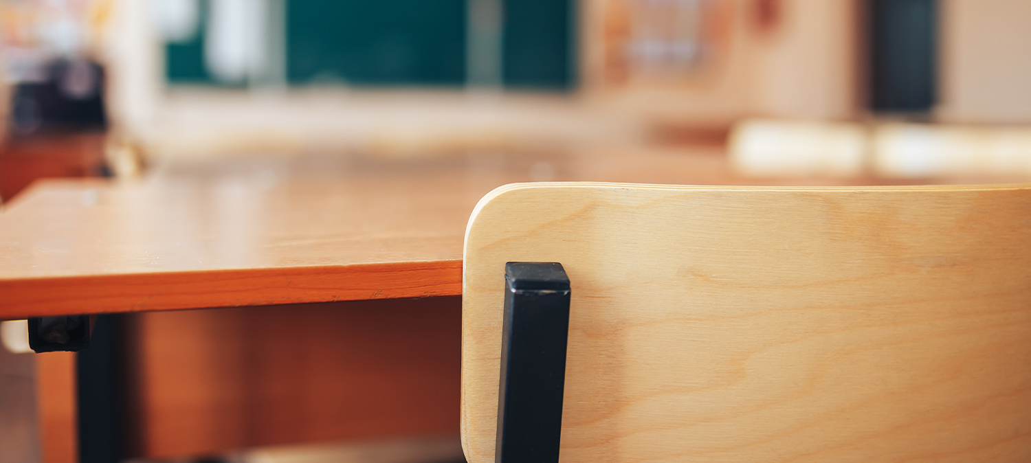 close up of a classroom desk and chair