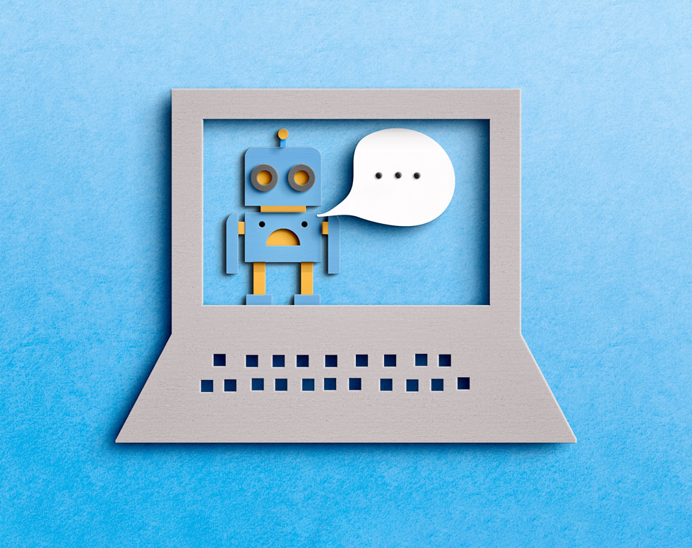 construction paper artwork of a robot with a speech bubble, taking place on a laptop screen