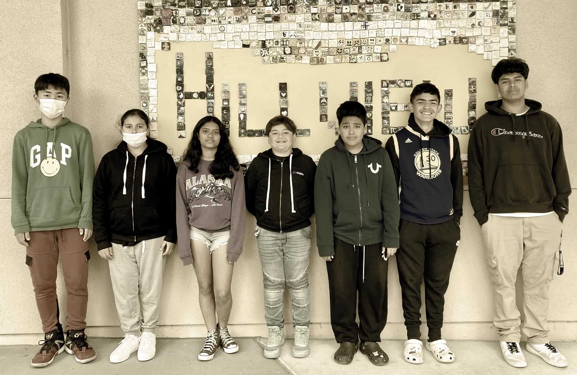 Hillview Middle School student members of the Menlo Park City SD’s English Fluency Reclassification Program stand up against a wall for a photo