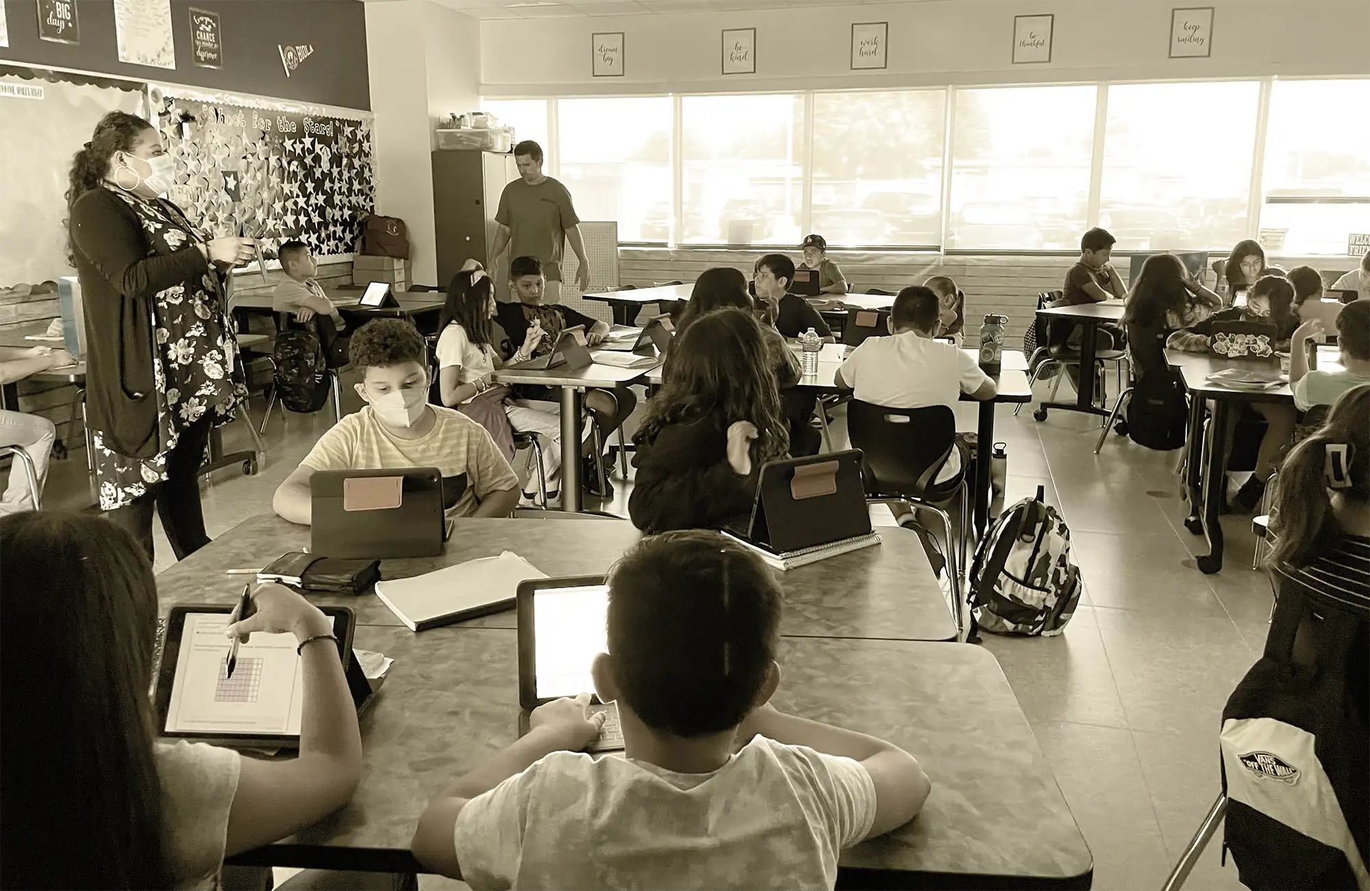 a classroom full of students using tablets during their lesson