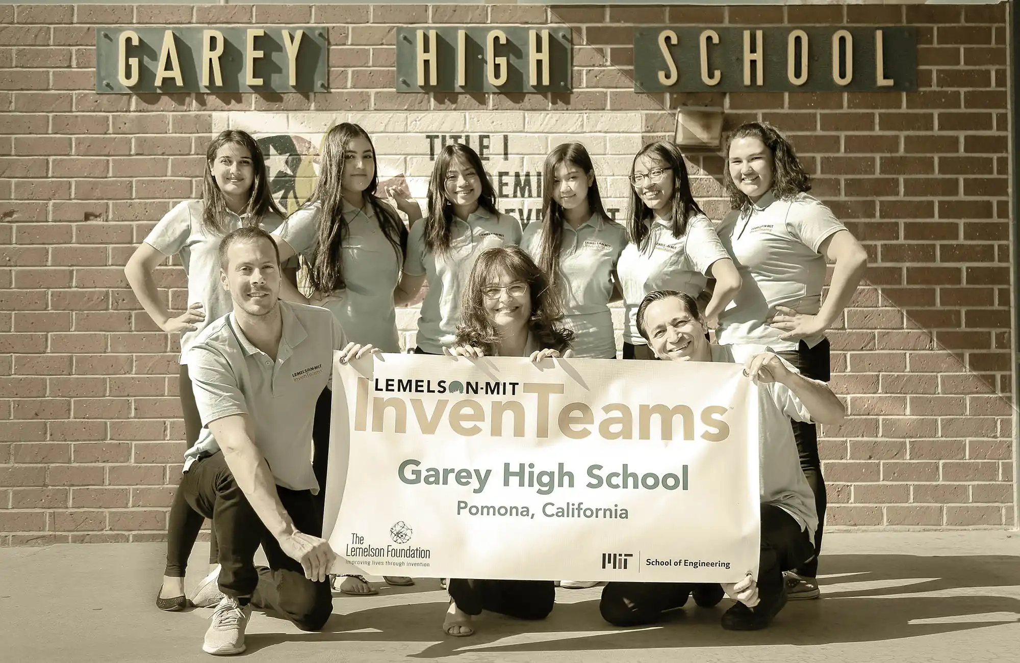 InvenTeams from Garey High School holding up a sign and smiling