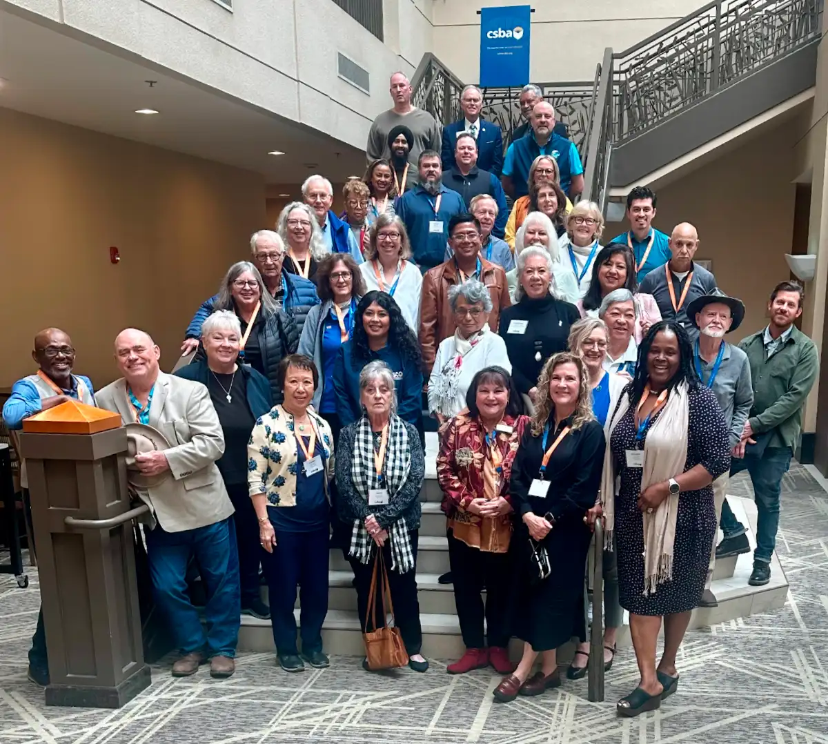 county board members posing together on a staircase at the CSBA County Board Workshop