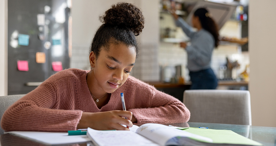 girl doing homework at a table