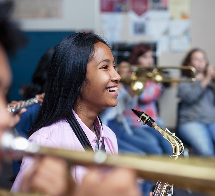 girl with a saxophone smiling