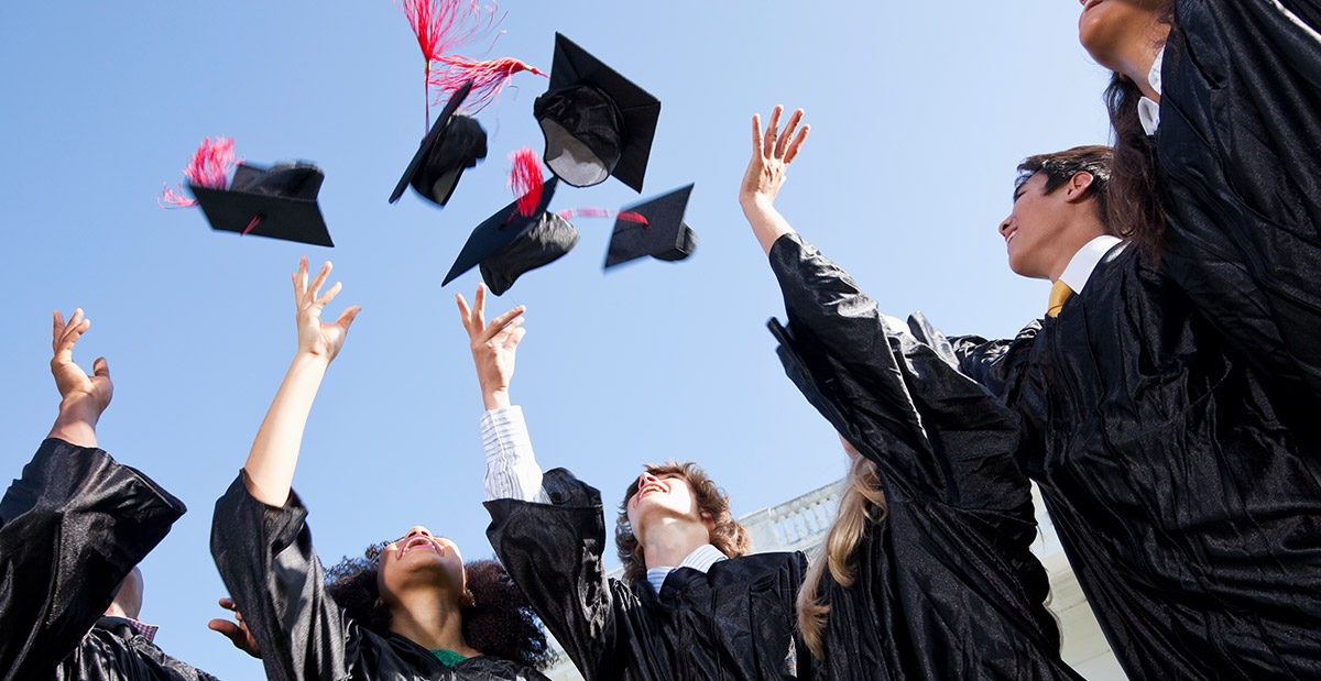 graduates throwing their caps in the air