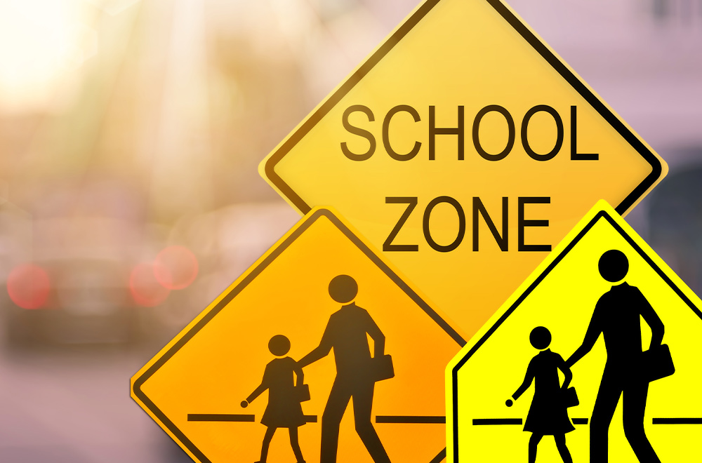 cropped view of three school zone traffic signs