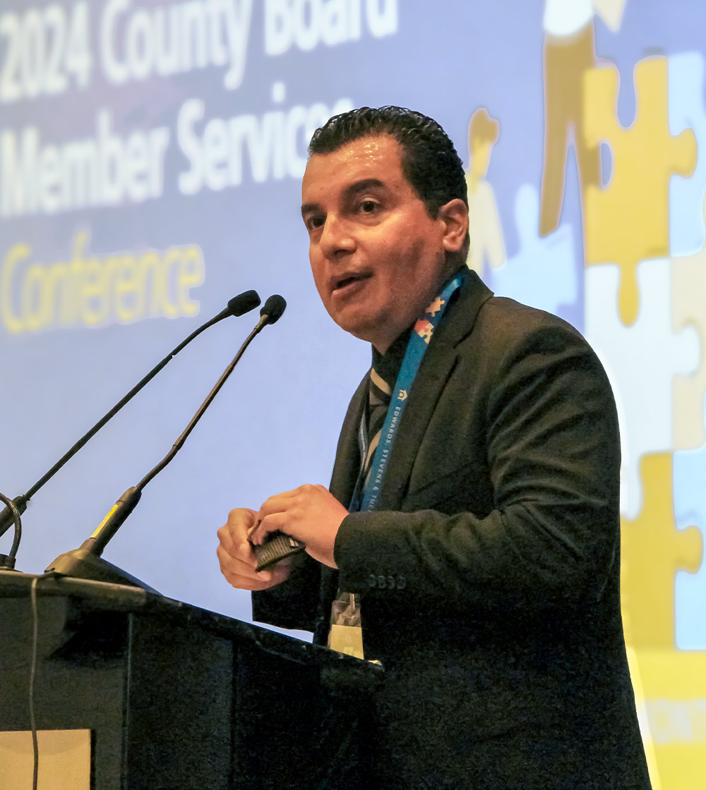 candid shot of CSBA President Albert Gonzalez addressing the audience from a podium