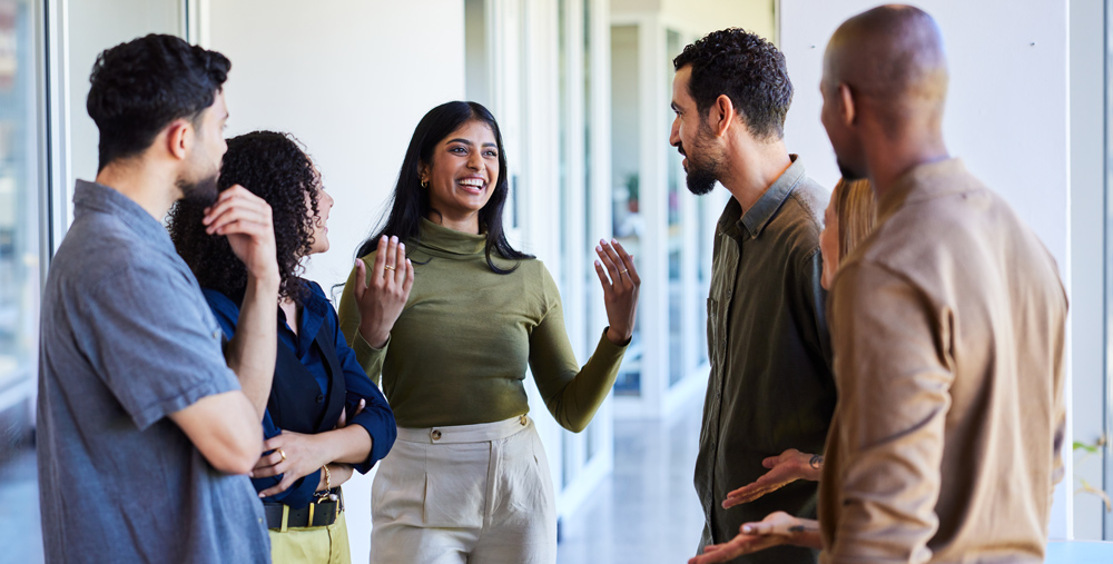 group of people talking and laughing together 