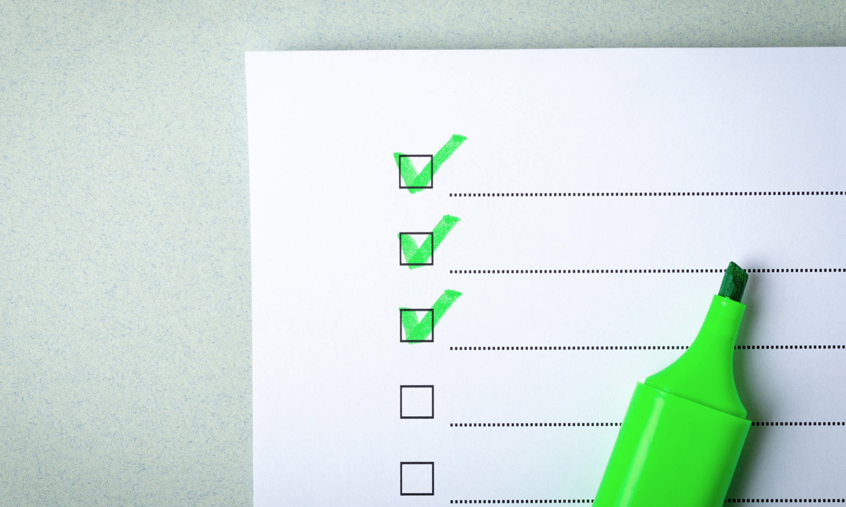 Checklist with checkmarks and a green marker