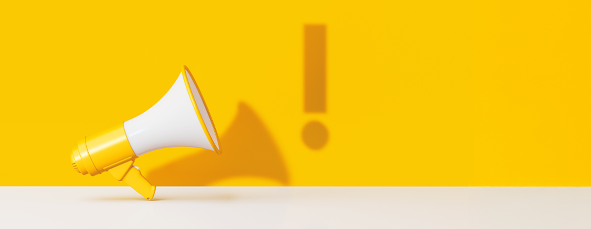 a bright yellow and white megaphone against a bright yellow background, an exclamation point shadow floats beside the megaphone's shadow