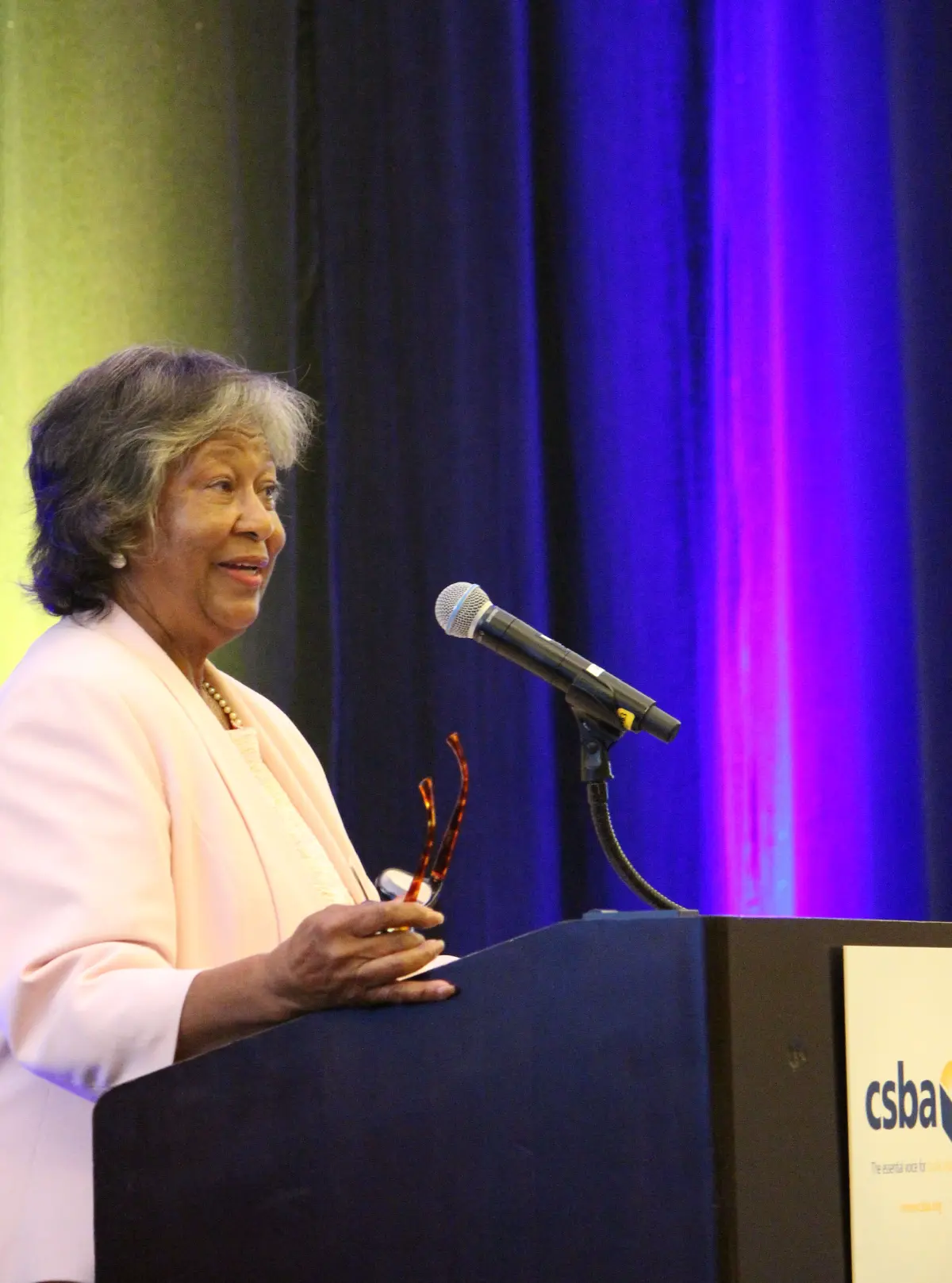 Dr. Bettye Lusk standing at a lectern