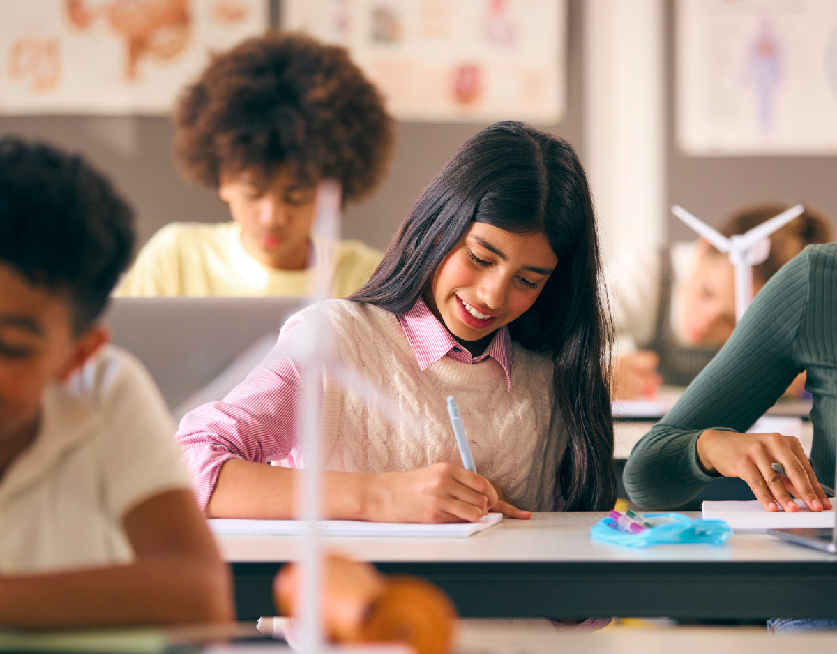 students writing in notebooks