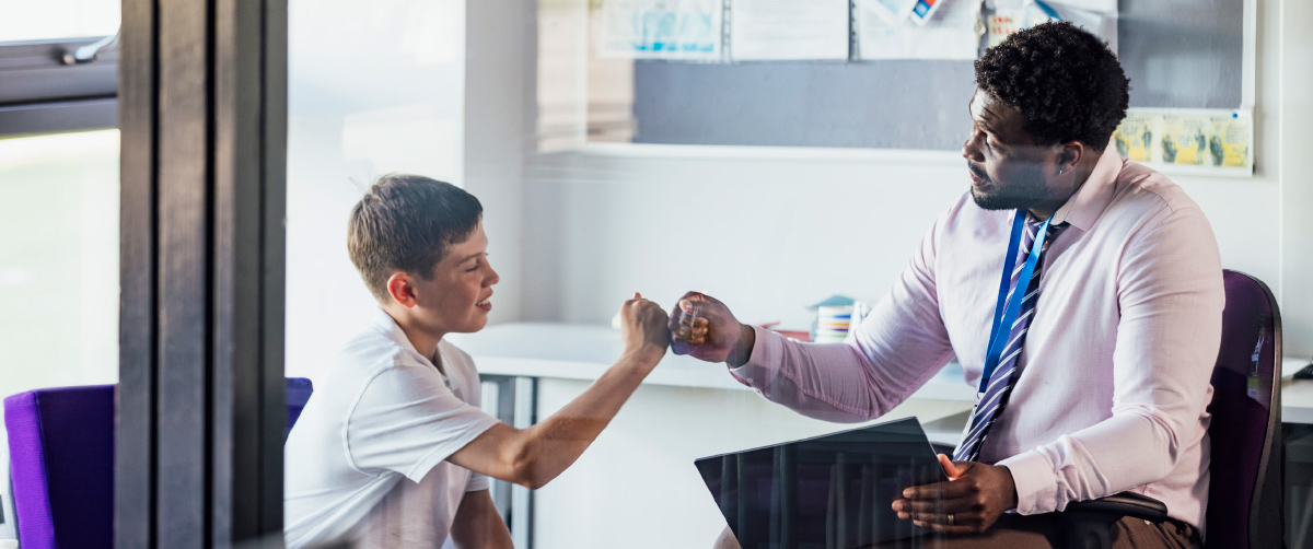 teacher and student fist bumping
