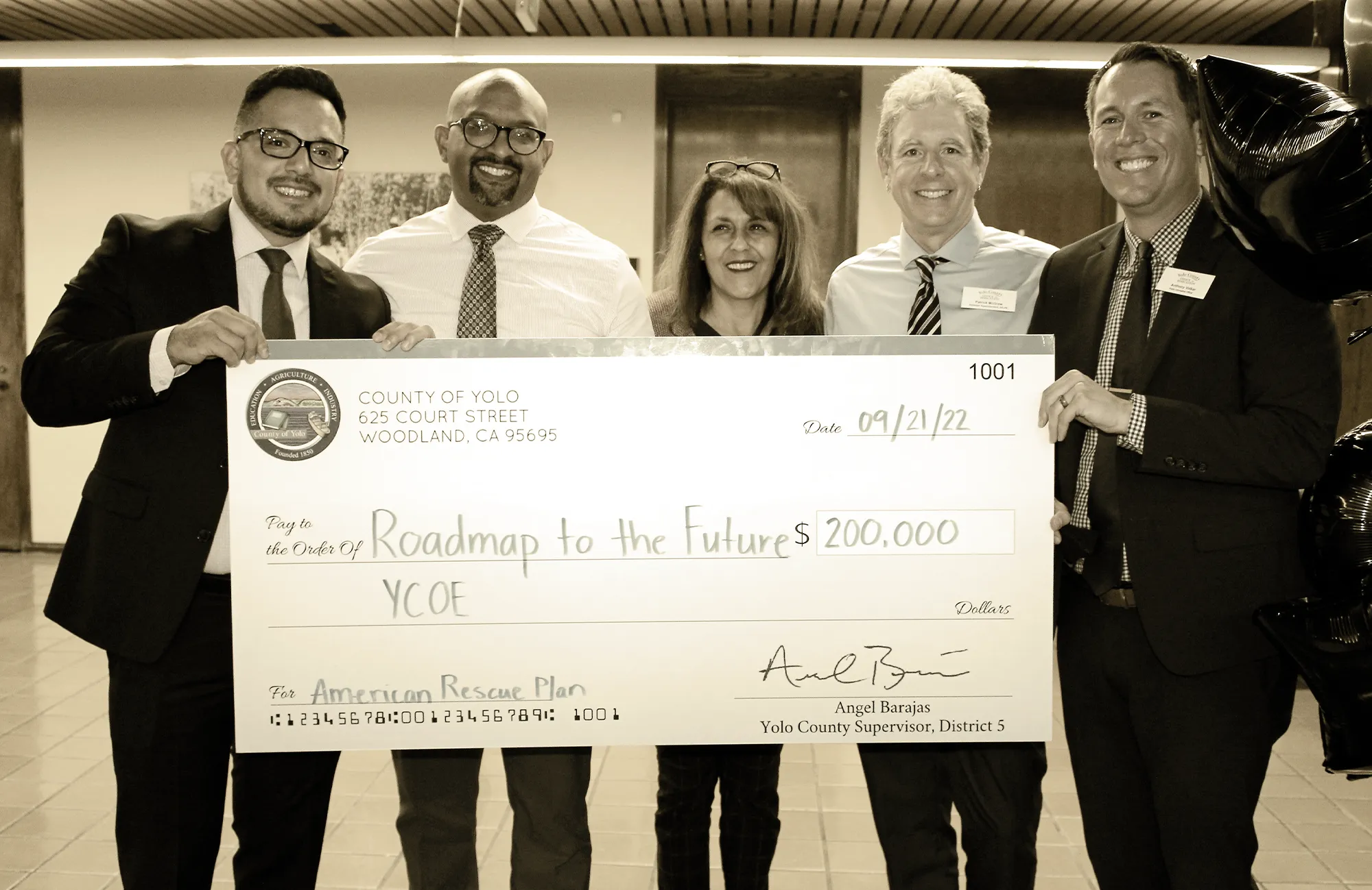 Five officials presenting a ceremonial check for $200,000 to the Yolo County Office of Education for the Roadmap to the Futures program.