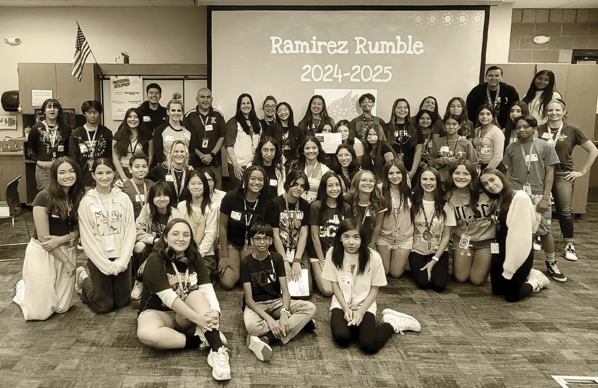 Large group of middle school students and staff posing for a photo in a classroom, celebrating the "Ramirez Rumble 2024-2025." Students are seated and kneeling in the front, with staff standing in the back.