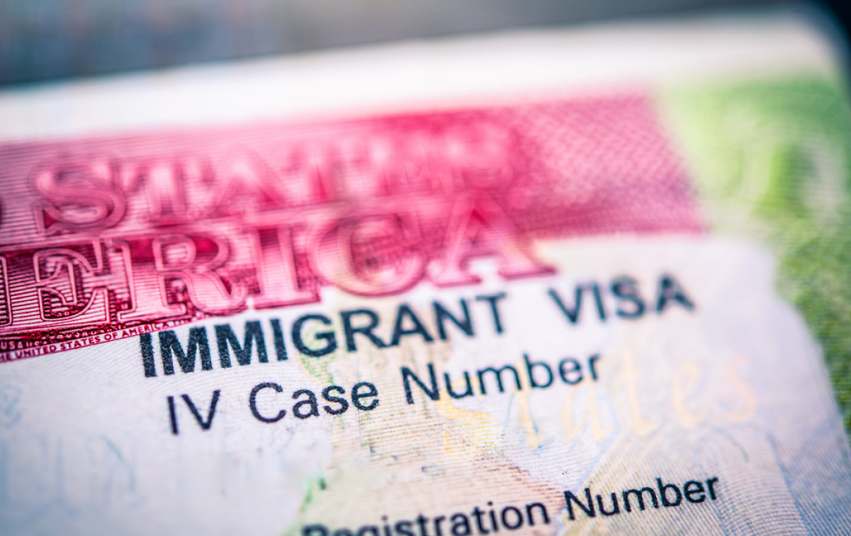 Close-up of a United States Immigrant Visa document showing "IV Case Number" and registration details.