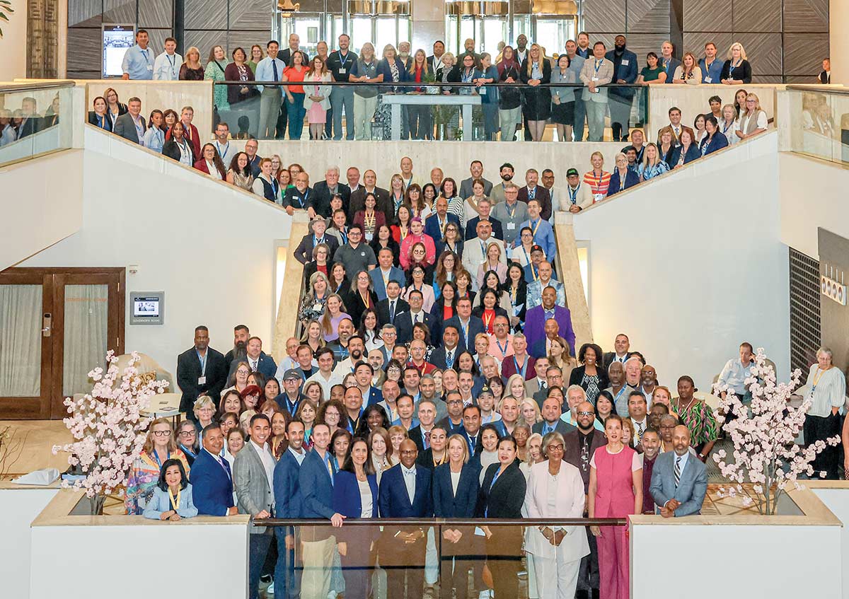 Participants posing at a staircase in the 2026 Coast2Coast Federal Advocacy Trip