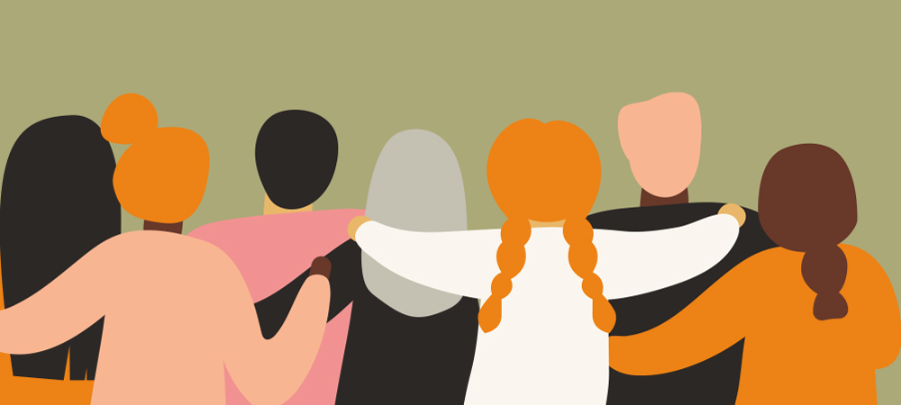 Flat vector illustration of six diverse people seen from behind, standing with their arms around one another’s shoulders all against a soft green background.